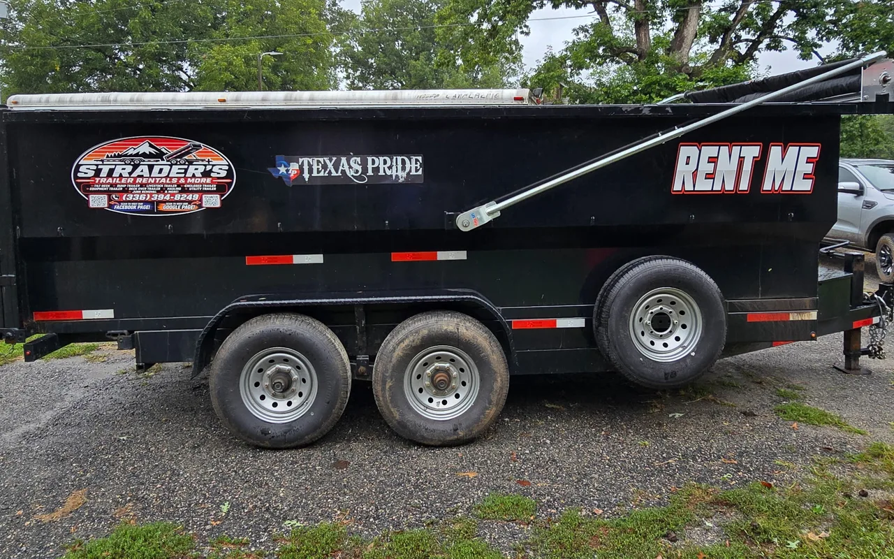 Black 7x16 dump trailer with RENT ME lettering and a mounted spare tire